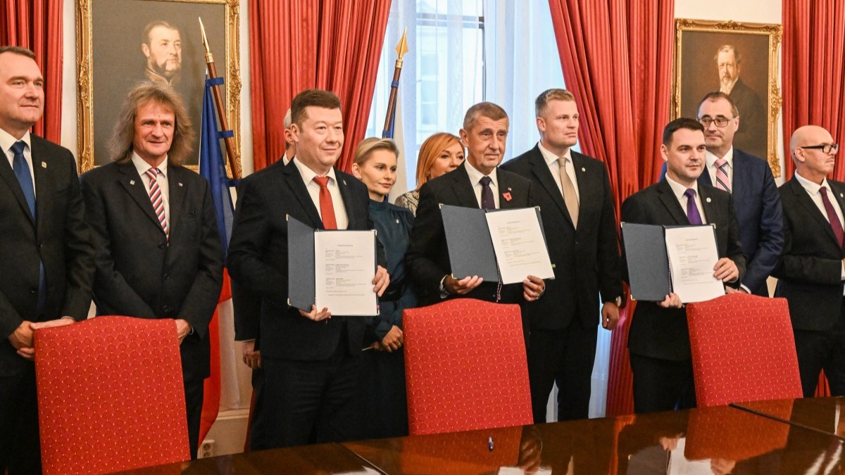 ANO leader and prime minister candidate Andrej Babiš (C) poses with his coalition partners after signing a new coalition government agreement at the Czech Parliament in Prague on November 3, 2025.
