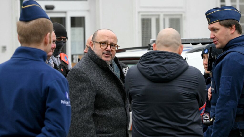 Belgium’s Interior Minister Bernard Quintin (2nd L), escorted by police, arrives at the Clemenceau metro station following a shooting, in Brussels on February 5, 2025.