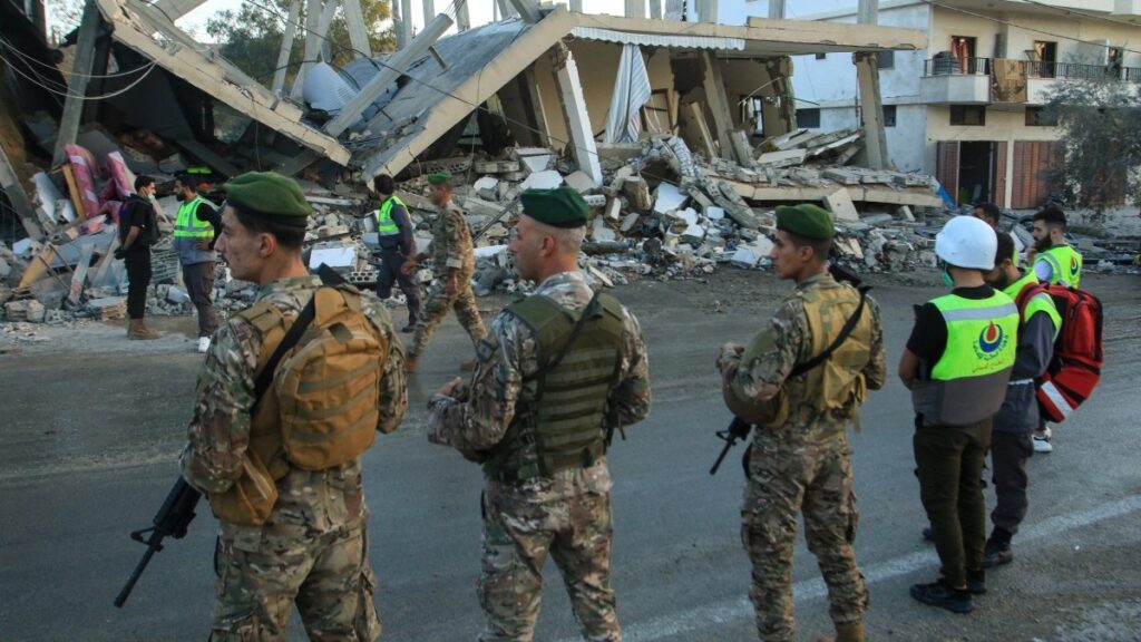 Lebanese army soldiers secure the site of an Israeli airstrike that targeted a building in the southern Lebanese village of Deir Kifa on November 19, 2025.