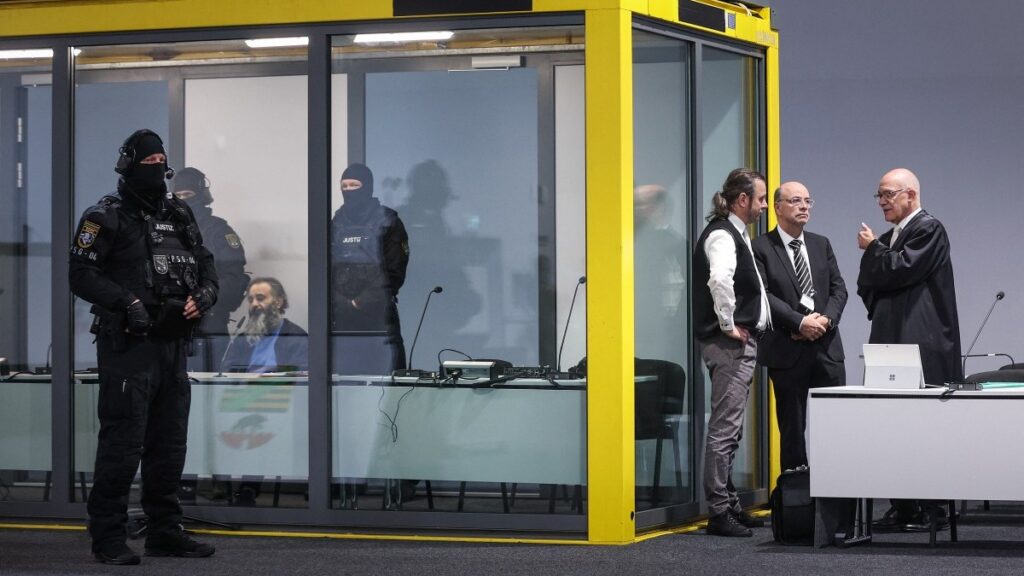 Taleb Jawad al-Abdulmohsen (L) sits in a bulletproof glass box in the courtroom in Magdeburg, Eastern Germany, on November 11, 2025, on the second day of his trial over the deadly Christmas market attack in December 2024.