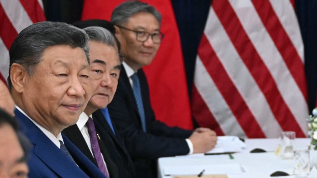 China’s President Xi Jinping (L), China’s Foreign Minister Wang Yi (2nd L) and China’s Commerce Minister Wang Wentao (R) attend talks with U.S. President Donald Trump (not pictured) at the Gimhae Air Base in Busan on October 30, 2025.