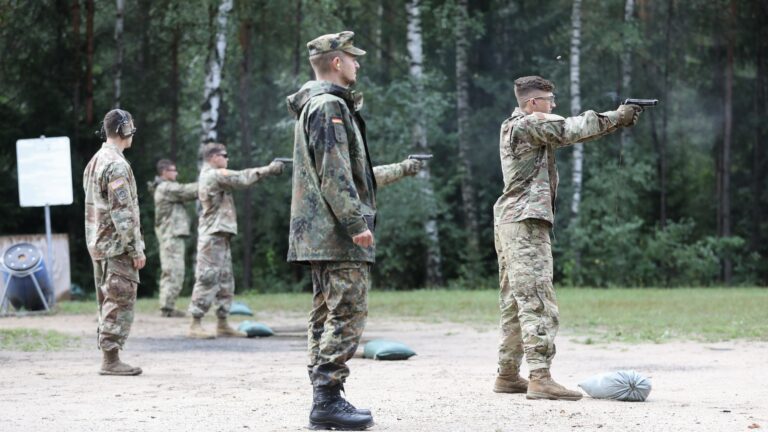 A Bundeswehr non-commissioned officer observes U.S. Army soldiers firing during a German Armed Forces Proficiency Badge qualification at a training area in Germany in 2019.