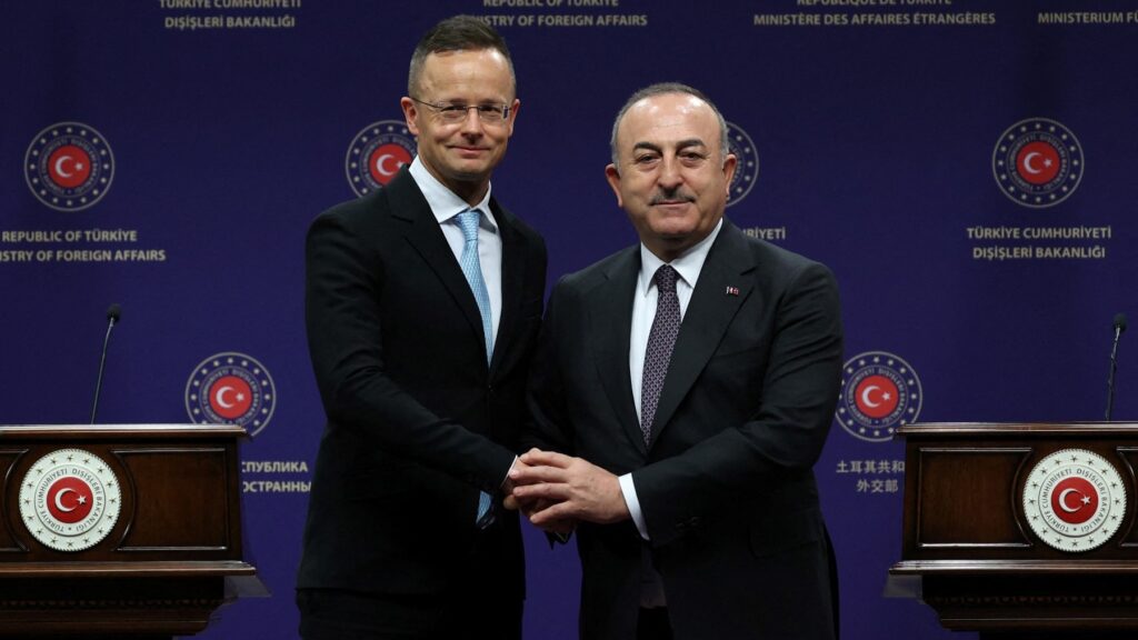 Turkish Foreign Minister Mevlüt Çavuşoğlu (R) and Hungarian Foreign and Trade Minister Péter Szijjártó (L) shake hands after holding a press conference following their meeting in Ankara, Turkey, on February 27, 2023.