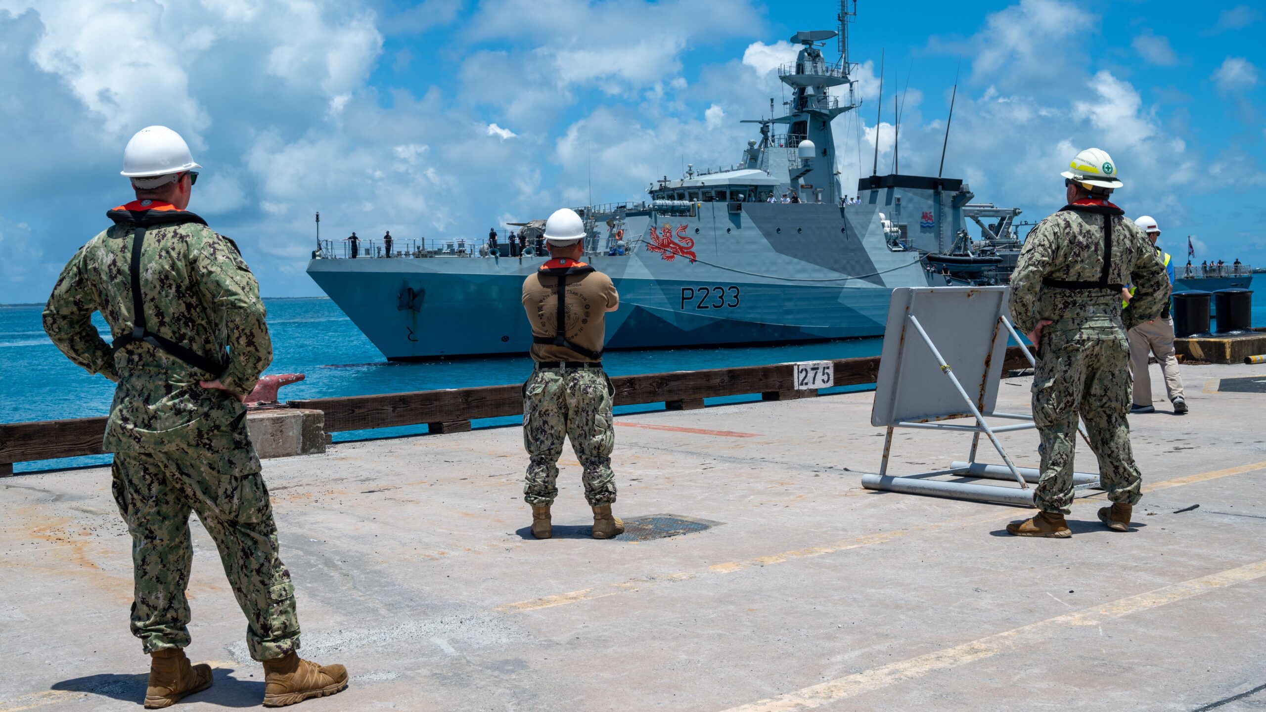 Sailors assigned to U.S. Navy Support Facility Diego Garcia watch as HMS Tamar (P233, an offshore patrol vessels operated by the Royal Navy, arrives in Diego Garcia for a scheduled port visit Feb. 15, 2023.