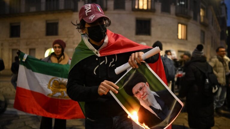 An anti-Iranian regime protester burns a photo depicting Ali Khamenei, Supreme Leader of Iran, outside the U.S. Consulate in Milan, on January 13, 2026.