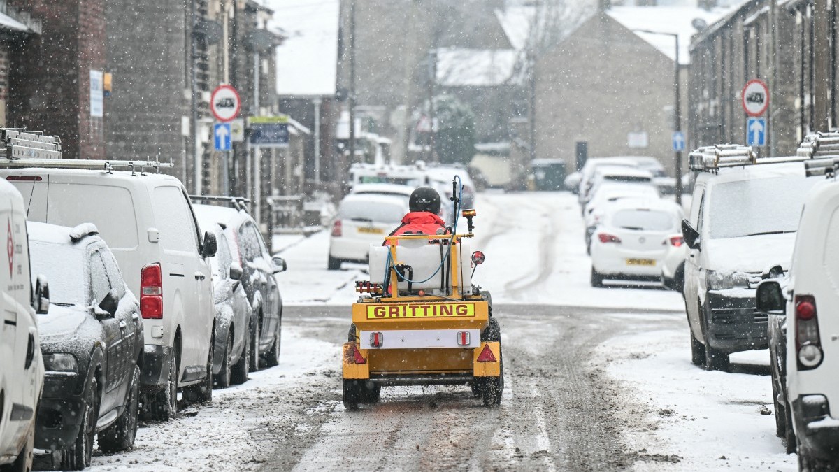 A man drives a small gritting vehicle to help clean the roads in the town of Glossop, Derbyshire, northern England on January 6, 2026, after a light snow covered the region overnight.
