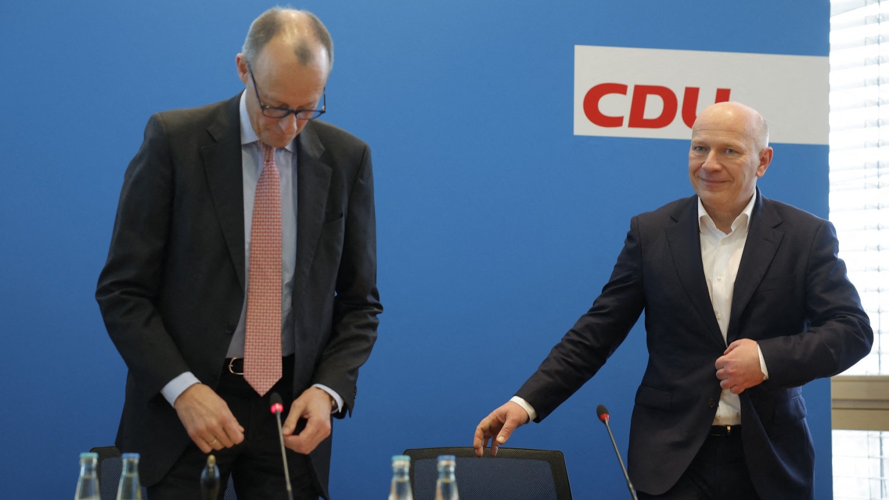 CDU top candidate Kai Wegner (R) and CDU leader Friedrich Merz (L) take a seat for a leadership meeting in Berlin on February 13, 2023, one day after the repeat Berlin state elections.