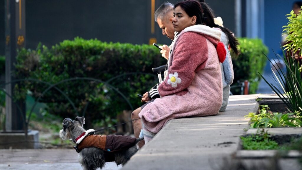 People seen waiting in the street after evacuating their home during a 6.5 magnitude earthquake in Mexico City, on January 2, 2026.