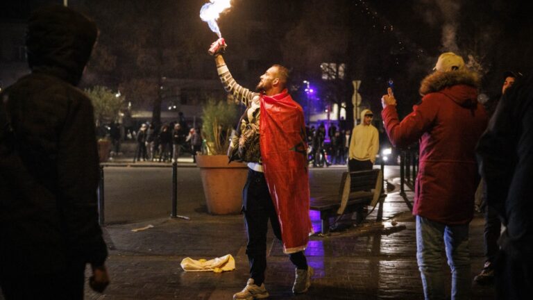 A supporter with a Moroccan national flag sprays fire in Brussels, on January 18, 2026 following the Africa Cup of Nations (AFCON) final football match between Senegal and Morocco played in Rabat, Morocco.