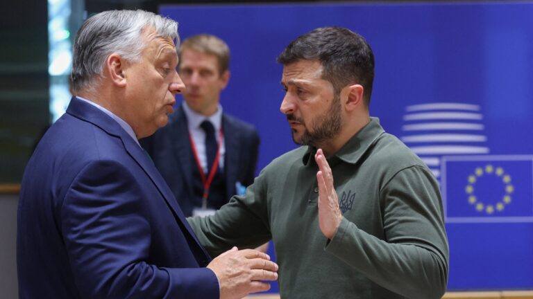 Hungarian Prime Minister Viktor Orbán (L) talks with Ukraine’s President Volodymyr Zelensky during the European Council Summit at the EU headquarters in Brussels on June 27, 2024.