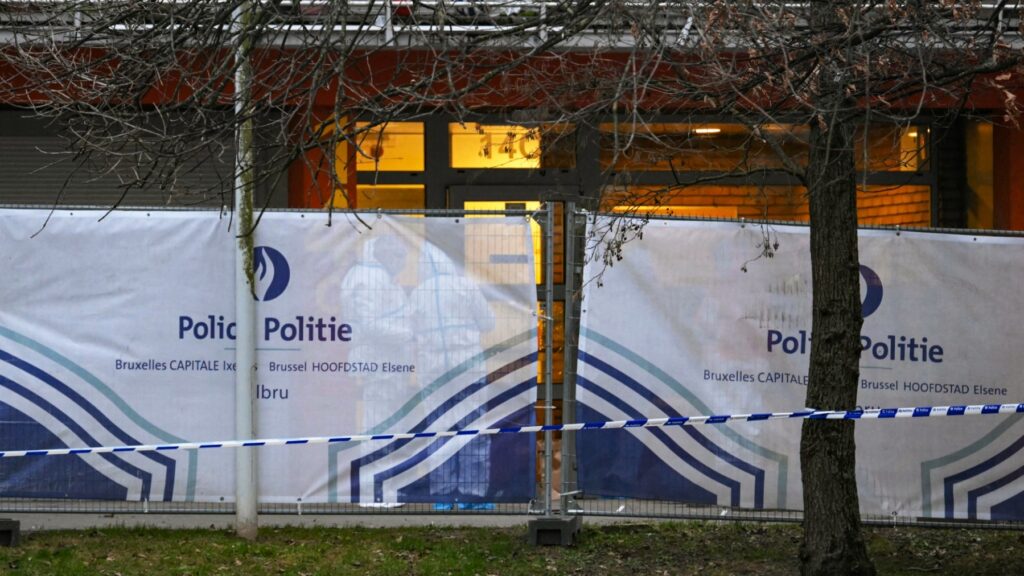 Investigators work behind a police fence where a man was killed overnight in a new shooting linked to drug trafficking in the municipality of Anderlecht, Brussels, on February 7, 2025.
