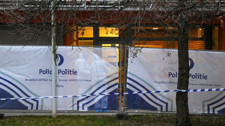 Investigators work behind a police fence where a man was killed overnight in a new shooting linked to drug trafficking in the municipality of Anderlecht, Brussels, on February 7, 2025.
