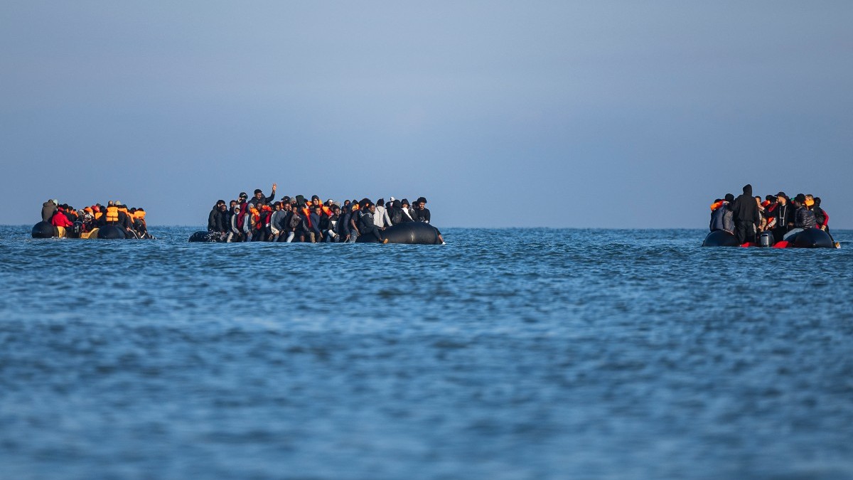 Smugglers’ boats sail with migrants onboard as they attempt to cross the English Channel off the beach of Gravelines, northern France on September 27, 2025.