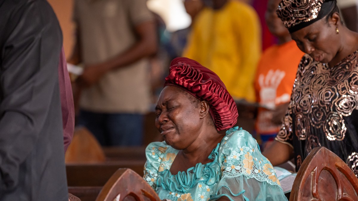 A worshipper prays at the Evangelical Church Winning All (ECWA) during a prayer called by the Christian Association of Nigeria (CAN) in Minna on December 7, 2025.