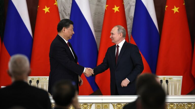 Russian President Vladimir Putin and General Secretary of the Chinese Communist Party Xi Jinping shake hands during a press conference following talks on March 21, 2023.
