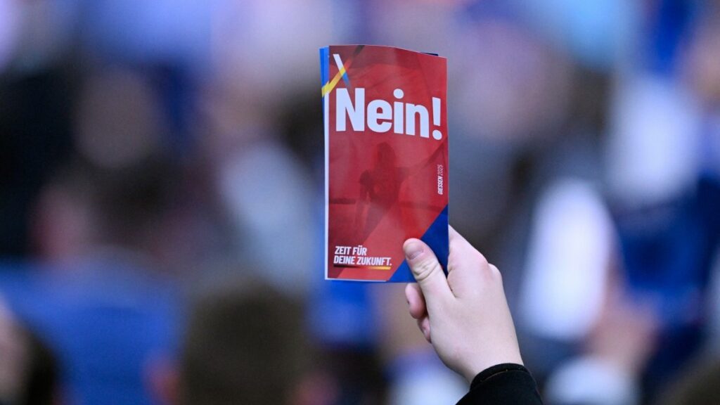 A delegate holds up a voting card saying “No” during a two-day convention of Alternative für Deutschland to establish its new youth organisation in Giessen on November 29, 2025.