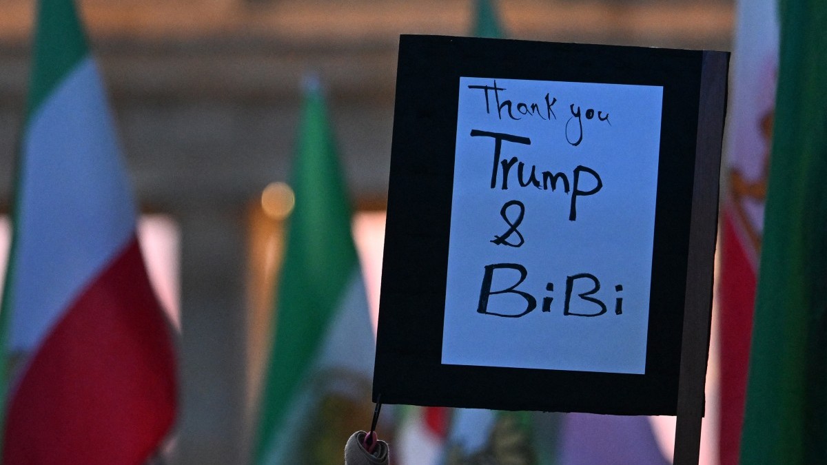 Protestors hold a placard which reads “Thank you Trump and Bibi (Benjamin Netanyahu)” during a demonstration “Freedom for Iran” in front of the Brandenburger Gate in Berlin, on February 28, 2026.