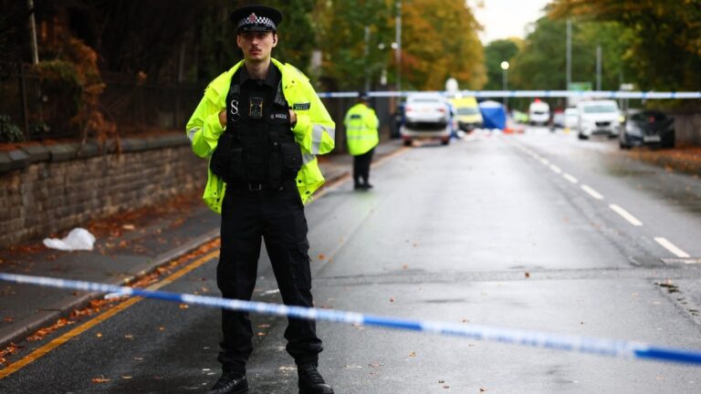 A police officer stands on duty at a cordon on the main road outside Heaton Park Hebrew Congregation synagogue in Crumpsall, north Manchester, on October 2, 2025, following an attack at the synagogue.