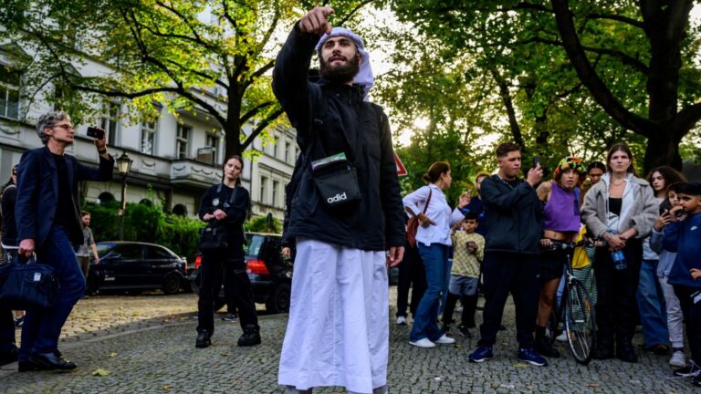 A Muslim preacher calls on Muslims to show themselves during a banned demonstration in support of Palestinians at Richardplatz, Neukölln, Berlin on October 11, 2023, four days after the October 7 Hamas pogrom in Israel.