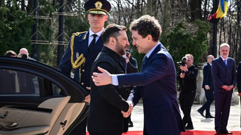 Romanian President Nicușor Dan (R) and his Ukrainian counterpart Volodymyr Zelensky arrive to address a press conference at Cotroceni Palace, the official residence of the Romanian president, in Bucharest on March 12, 2026.