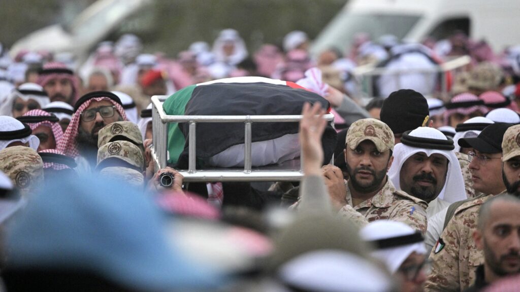 Mourners carry the flag draped body of a Kuwaiti soldier who was killed in an Iranian strike on Kuwait, at the Sulaibikhat cemetery, west of Kuwait City on March 3, 2026.