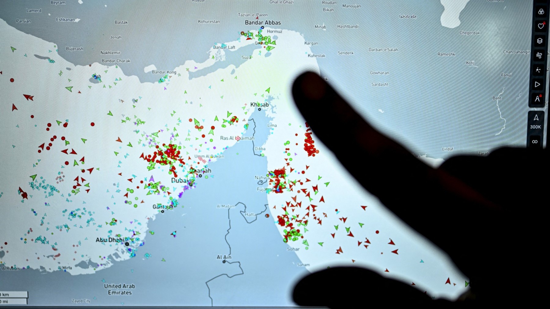 A person points at a page on the Marinetraffic website that shows commercial boats traffic on the edge of the Strait of Hormuz near the Iranian coast, in Paris on March 4, 2026.
