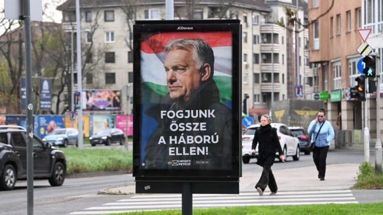 A billboard featuring a portrait of Hungarian Prime Minister Viktor Orbán with the text reading “Let’s join forces against the war, is seen in Budapest on March 27, 2026, ahead of the parliamentary elections on April 12, 2026.