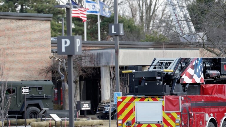 Law enforcement remain on site at the Temple Israel synagogue in West Bloomfield, Michigan, a Detroit suburb, on March 12, 2026, after an assailant drove a vehicle into the building.