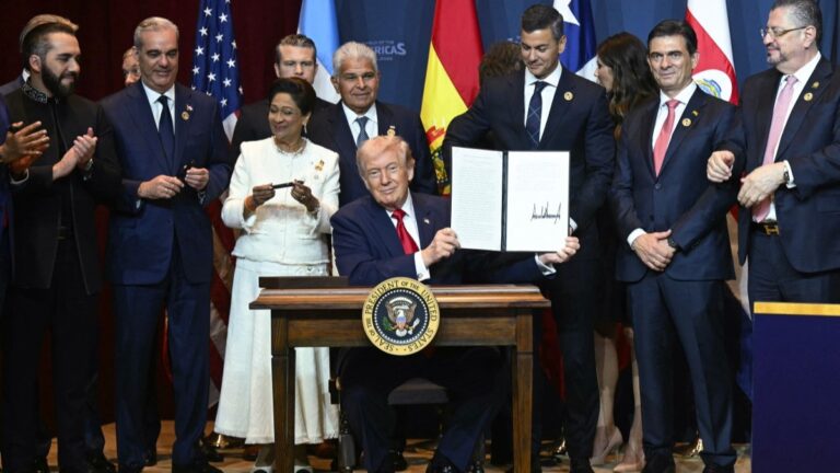 U.S. President Donald Trump holds up a newly-signed proclamation at the "Shield of the Americas" Summit at Trump National Doral in Miami, Florida, March 7, 2026.
