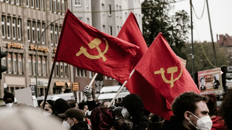 People raising red flags with the communist 'hammer and sickle' symbol at a May 1 leftist rally in Berlin, Germany in 2021