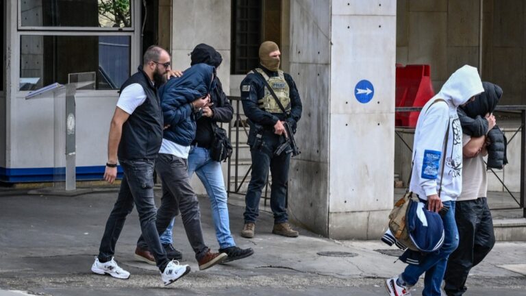 Arrested suspects, allegedly “involved in large-scale agricultural funding fraud and money laundering” according to the European public prosecutor's office (EPPO), are escorted by plainclothes police officers in Athens on October 23, 2025.