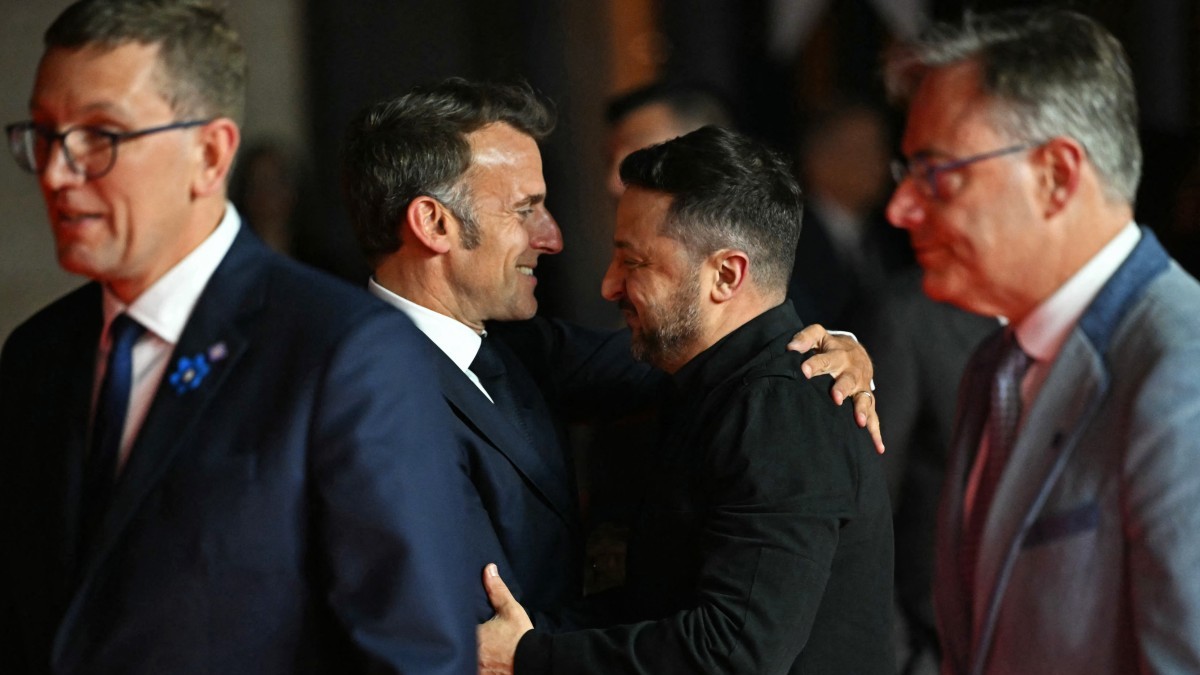 France’s President Emmanuel Macron (2L) embraces his Ukraine’s President Volodymyr Zelensky ahead of an informal meeting of the European Council, in Ayia Napa on April 23, 2026.