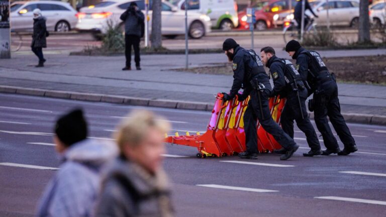 Police officers move anti-terror barriers in front of St John’s Church in Magdeburg, eastern Germany, on January 16, 2025, during a memorial wreath-laying ceremony for the victims of the Christmas market attack.