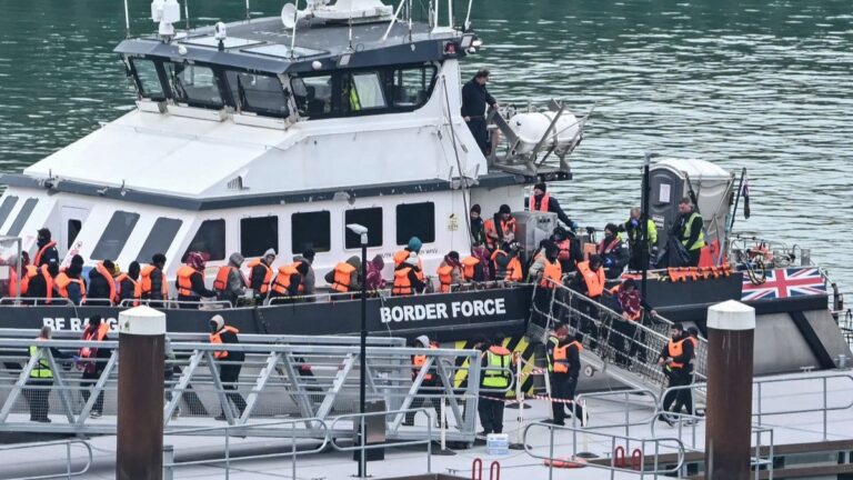 Migrants disembark a British Border Force vessel after being picked up at sea, while attempting to cross the English Channel, at the Dover in southeast England, on April 1, 2026.