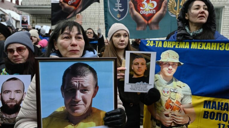 Families hold portraits of their missing or captured relatives and friends as released Ukrainian prisoners of war arrive after a prisoners exchange in the Chernigiv region on March 5, 2026.