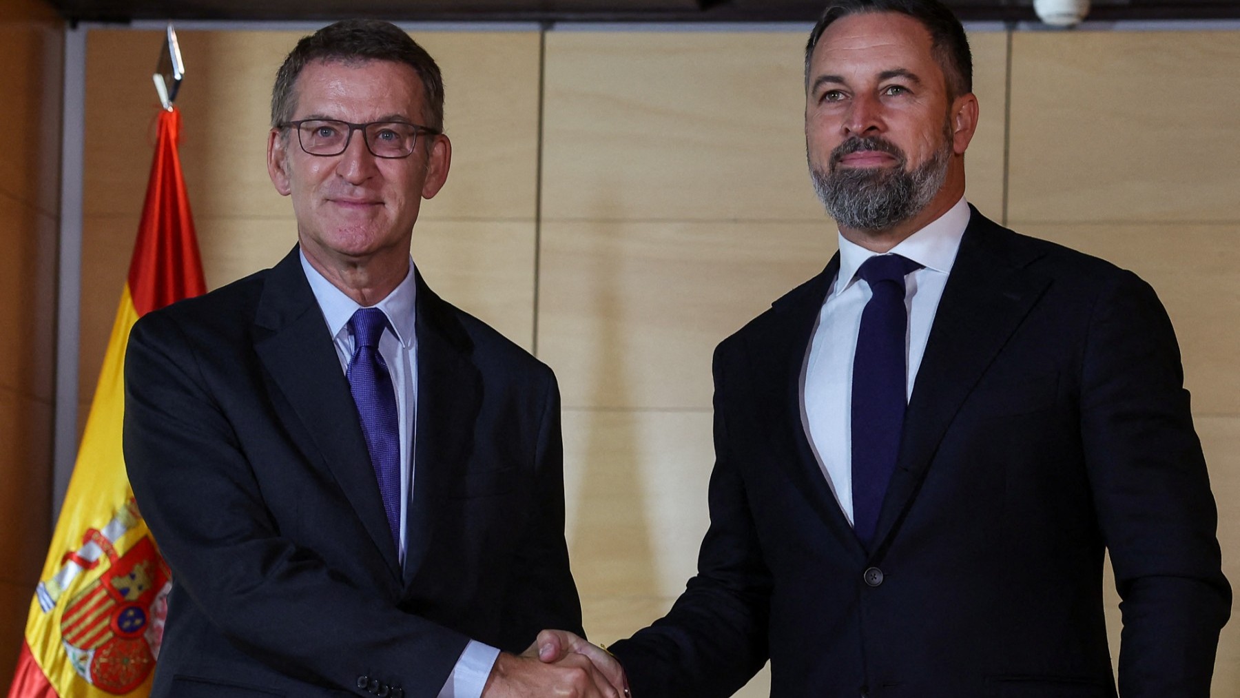 People's Party (PP) President Alberto Núñez Feijóo (L) shakes hands with VOX far-right party's leader Santiago Abascal as they arrive for a meeting at the Congress of Deputies in Madrid, on September 5, 2023.