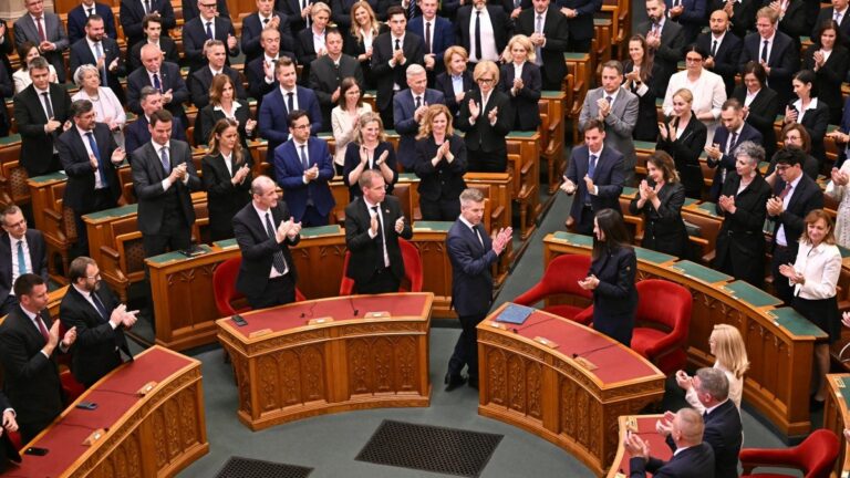 Hungary’s new Prime Minister Péter Magyar (front C-R) applauds during the swearing-in ceremony for the new cabinet ministers at the Hungarian Parliament in Budapest on May 12, 2026.