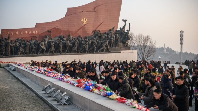 People visit Mansu Hill to lay bouquets of flowers to pay their respects in front of statues of late North Korean leaders Kim Il Sung and Kim Jong Il, to mark the fourteenth anniversary of the death of Kim Jong Il, the father of current leader Kim Jong Un, in Pyongyang on December 17, 2025.