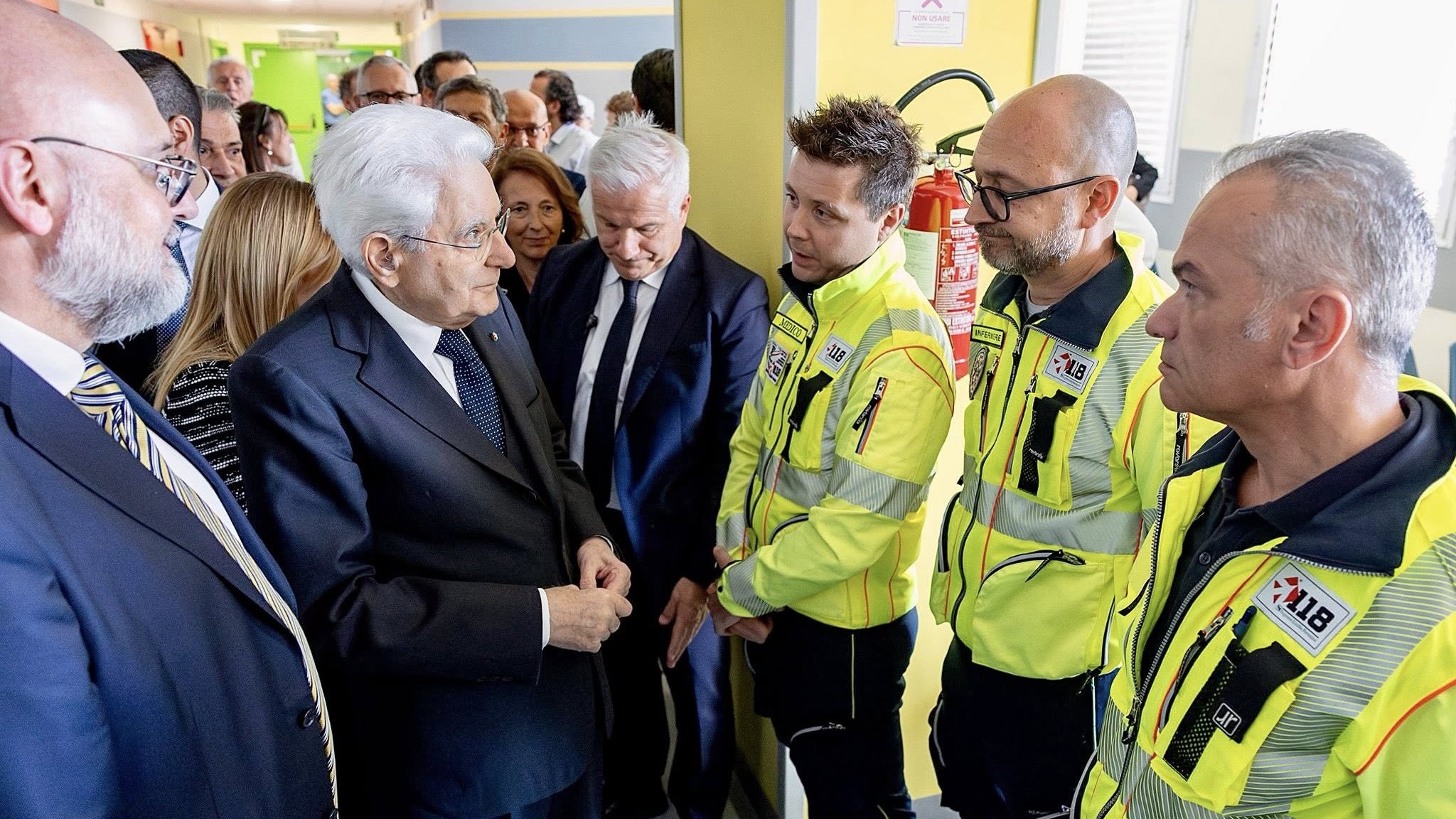 Italian President Sergio Mattarella and Prime Minister Giorgia Meloni (C, partially visible) with Modena Mayor Massimo Mezzetti talk to staff at the Baggiovara hospital on May 17, 2026.