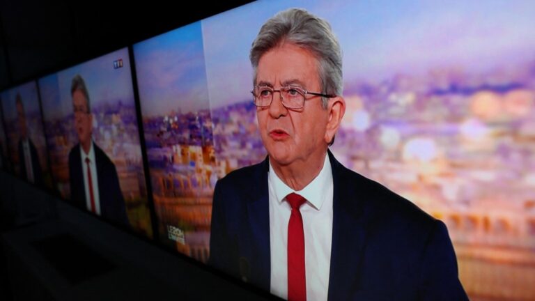 La France Insoumise (LFI) leader Jean-Luc Mélenchon is seen on screens as he announces his candidacy for the 2027 French presidential election on the French TV channel TF1's evening news program, in Paris, on May 3, 2026.