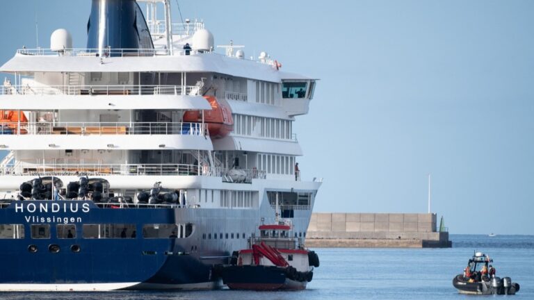 Boats approach the Dutch flagged hantavirus-stricken cruise ship MV Hondius after it arrived at the industrial port of Granadilla de Abona on the island of Tenerife in Spain's Canary Islands on May 10, 2026.