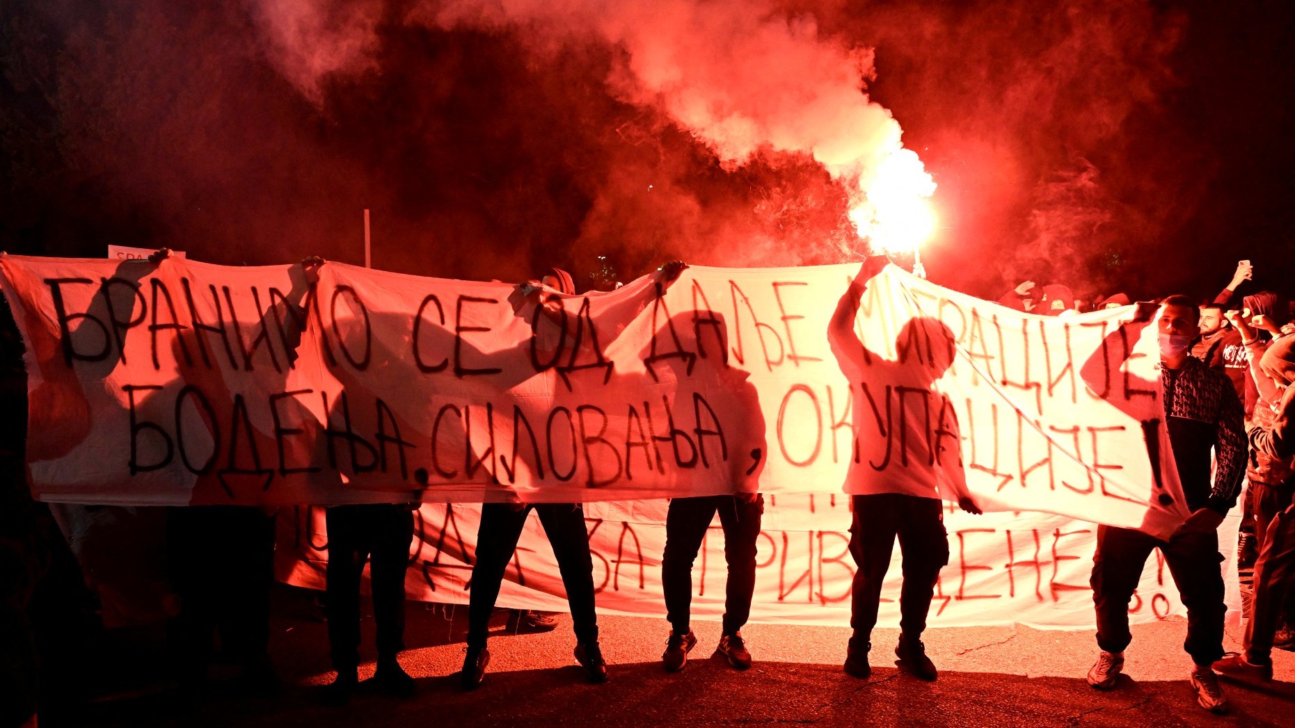 Demonstrators hold a banner reading “Defending Ourselves From Further Migration, Stabbings, Rape and Occupation” during protest in Montenegro's capital Podgorica on October 28, 2025, following the stabbing of a Montenegro national.
