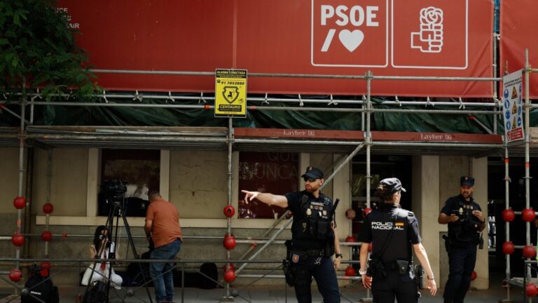 Spanish National Police officers stand guard outside the ruling Spanish Socialist Party (PSOE) headquarters after agents from the UCO, the Civil Guard unit specializing in complex and sensitive investigations, entered the premises to demand documents, in Madrid, on May 27, 2026.