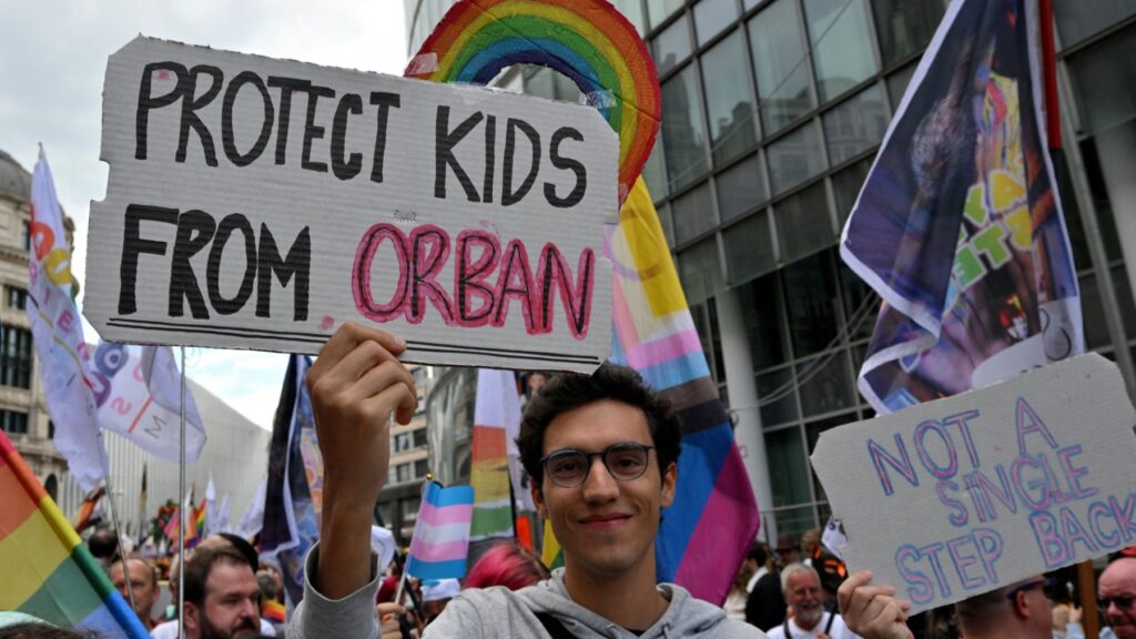 A man holds a placard as he takes part in the LGBT Pride in Brussels on May 17, 2025.