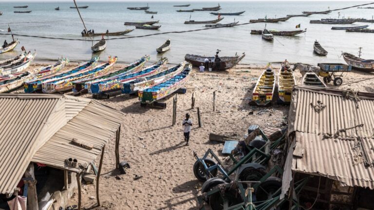 A boy walks on a beach known as “the airport”, a departure point used by migrants trying to reach Europe through the Atlantic route in Mbour, on March 9, 2026.
