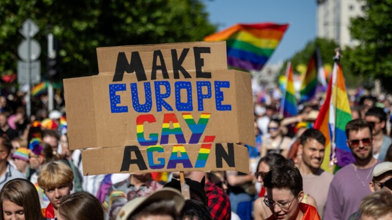 Participants of the Warsaw Pride parade with rainbow-colored flags celebrate in the streets of Warsaw, Poland, on June 14, 2025.