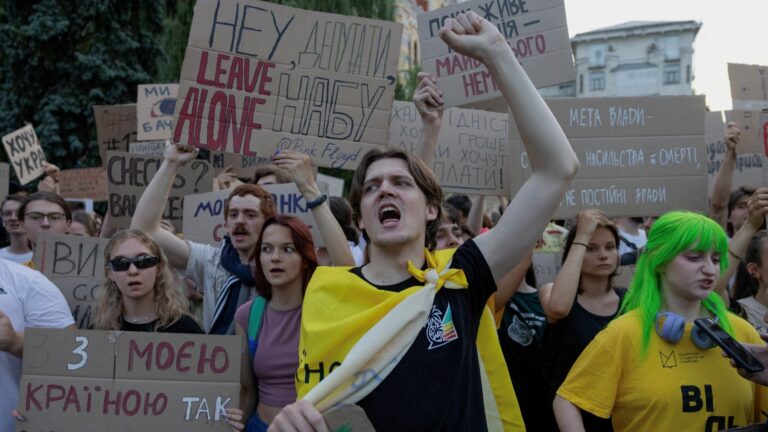 Protesters shout slogans and hold placards during a demonstration against a law (later repealed) that removed the independence of the NABU and SAPO anti-corruption agencies, in Kyiv on July 24, 2025.