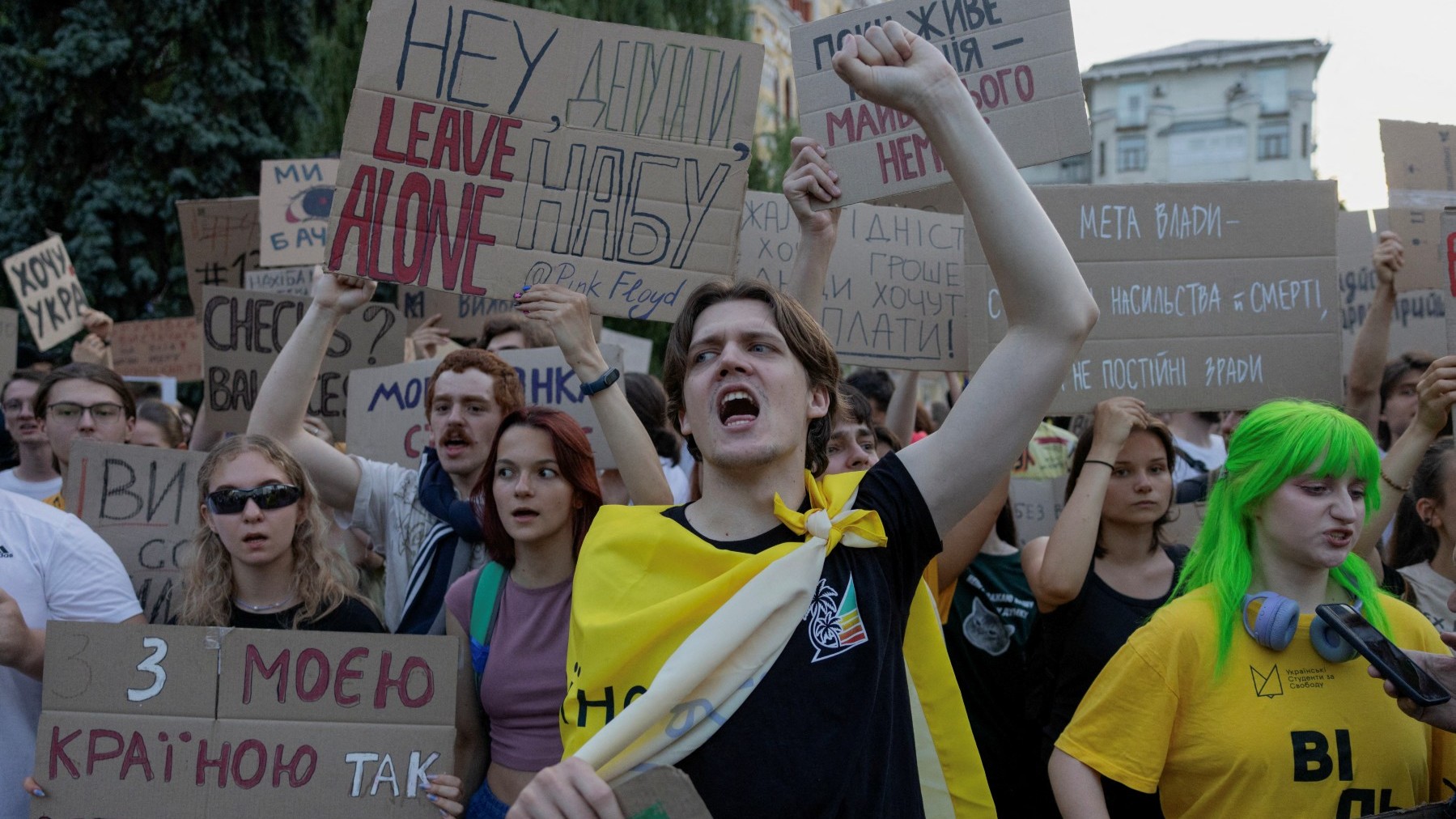 Protesters shout slogans and hold placards during a demonstration against a law (later repealed) that removed the independence of the NABU and SAPO anti-corruption agencies, in Kyiv on July 24, 2025.