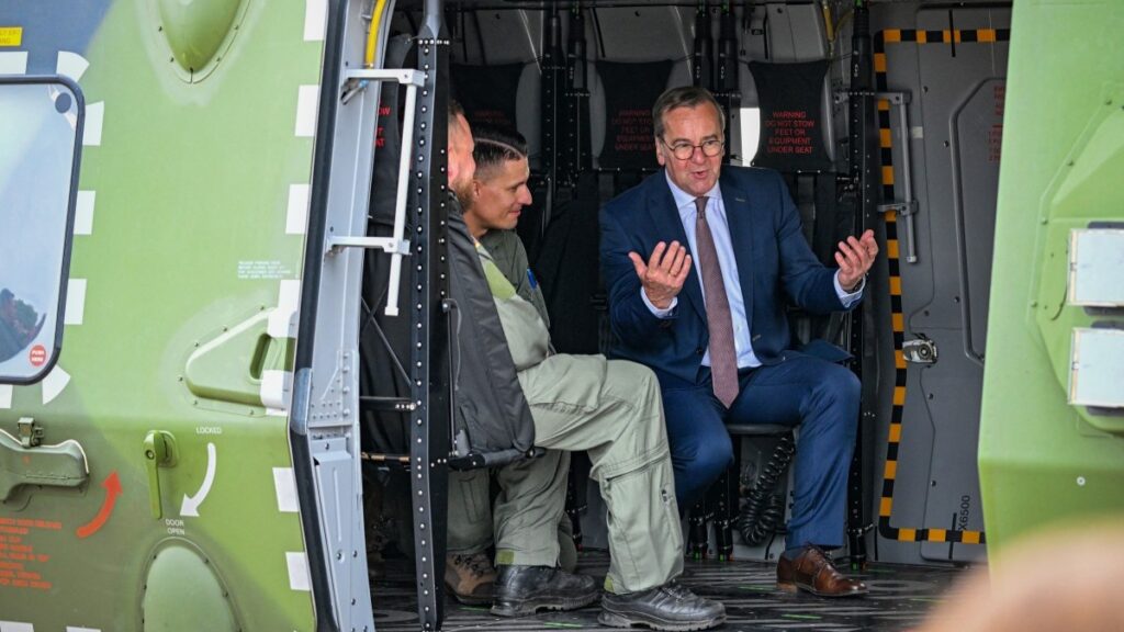 German Defence Minister Boris Pistorius talks with German soldiers as he sits in a military helicopter of the German armed forces Bundeswehr near Berlin, on June 12, 2026.