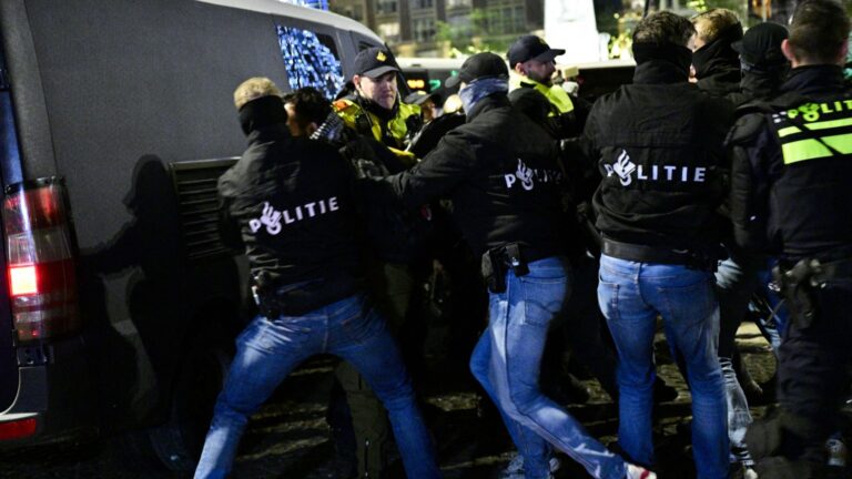 Dutch special unit police officers detain a protestor during an unauthorised pro-Palestinian demonstration on Dam Square in Amsterdam on November 13, 2024.